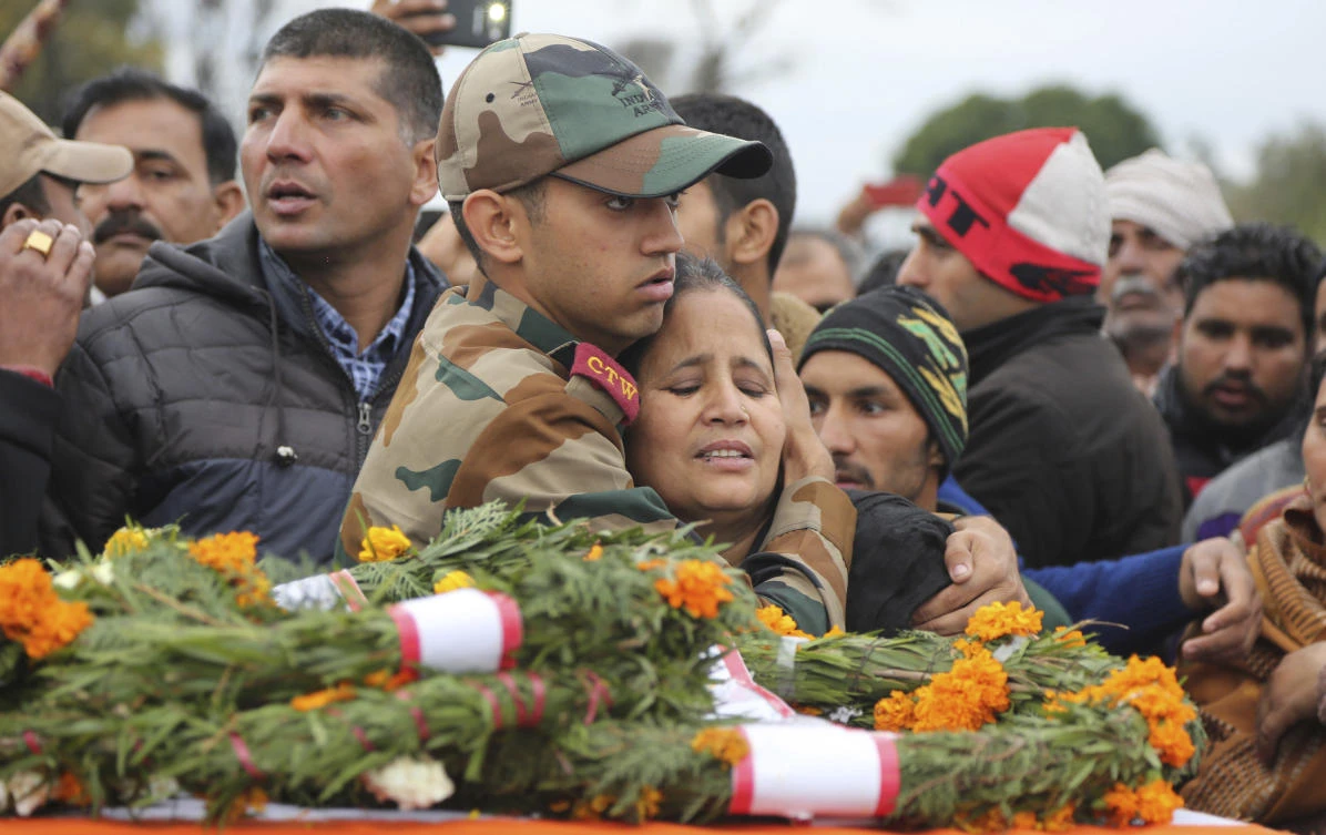 Son Ankush Choudhary, center, tries to console his mother Charanjeet Kaur during the funeral of Indian army soldier Madan Lal Choudhary, who was killed in Saturday’s militant attack on Indian army camp, at village Bakrak, in Hiranagar, district Kathua, 72 kilometers (45 miles) south of Jammu, India, Monday, Feb.12, 2018. (AP)
