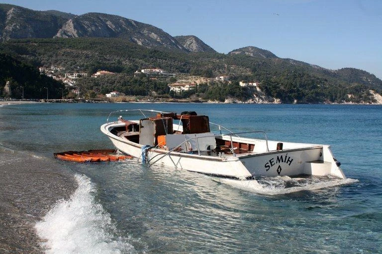 A boat that carried refugees lies semi-submerged off Samos Island, Greece. Three refugees died when a boat capsized on the Maritsa River, which flows between Turkey and Greece. (AP)