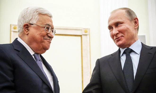 Russian President Vladimir Putin, right, shakes hands with Palestinian leader Mahmoud Abbas during their meeting at the Kremlin in Moscow on Monday. (AFP)