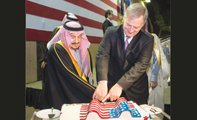 Riyadh Gov. Prince Faisal bin Bandar cuts a cake with Charge D’Affaires Christopher Henzel during US Independence Day celebration in Riyadh on Monday.