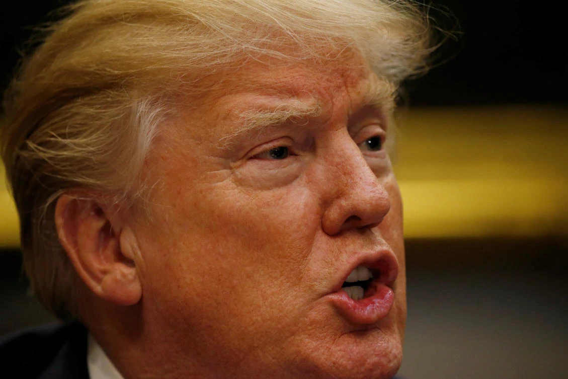 U.S. President Donald Trump speaks to members of the National Sheriffs' Association during a roundtable with them at the White House in Washington, U.S., February 13, 2018. REUTERS/Leah Millis
