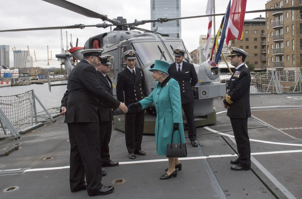 In this Oct. 23, 2017, file photo, ship's officers are presented to Britain's Queen Elizabeth II on deck during her visit to HMS Sutherland, a Type 23 frigate, in the West India Dock, in London. (AP)
