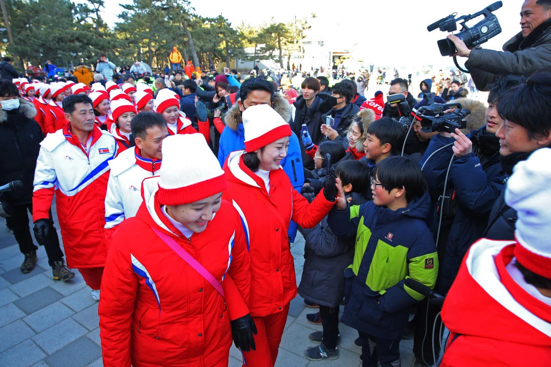 A group of North Korean cheerleaders for the Pyeongchang Winter Olympics greets South Koreans as they visit Gyeongpo Beach in Gangneung. (Yonhap via AP)