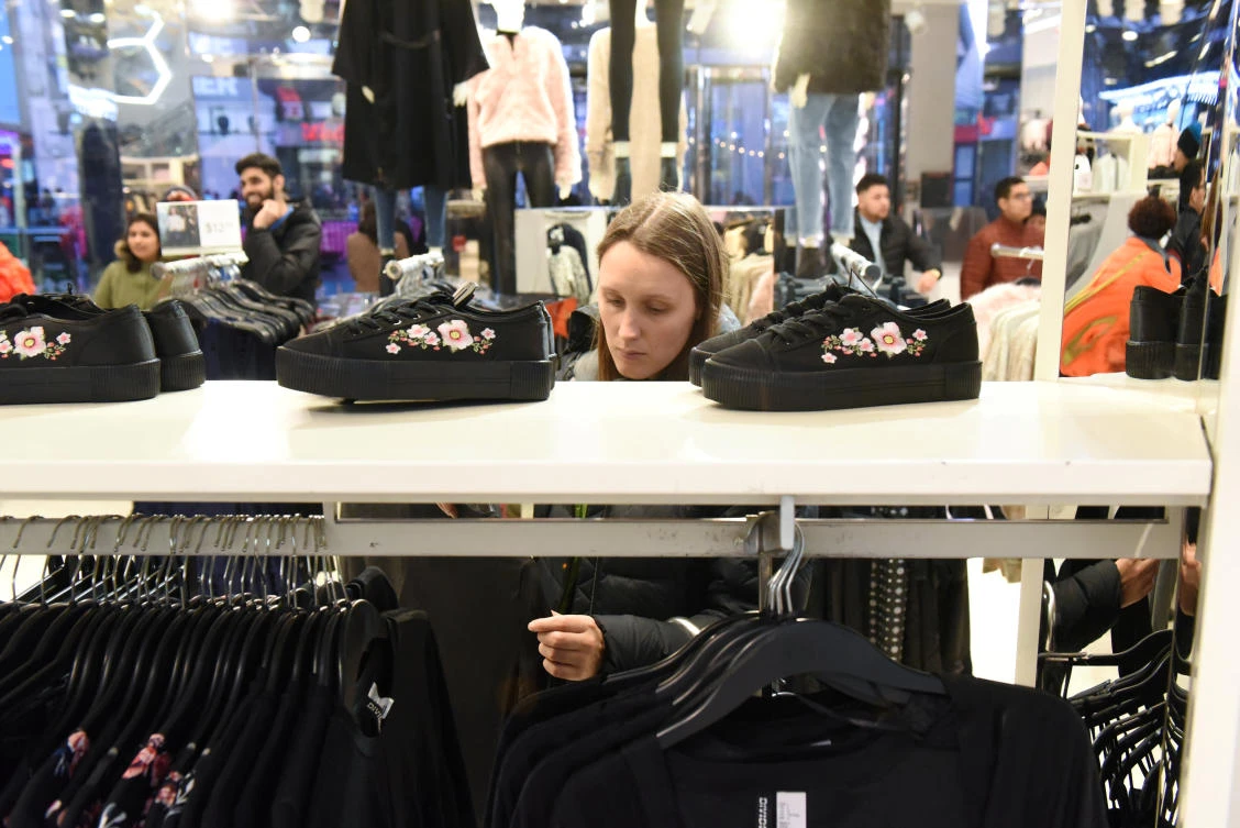 A woman shops at an H&M store in New York City. The retailer is seeing a pickup in online sales. (Reuters)