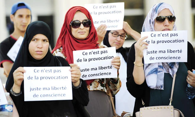 Women hold signs reading ‘Is it not a provocation, just my freedom of conscience’ during a ‘headscarf march’ organized by the Collective against Islamophobia ‘Respect Equality Dignity’ on Sept. 3, 2016, in Avignon, southern France. (AFP)