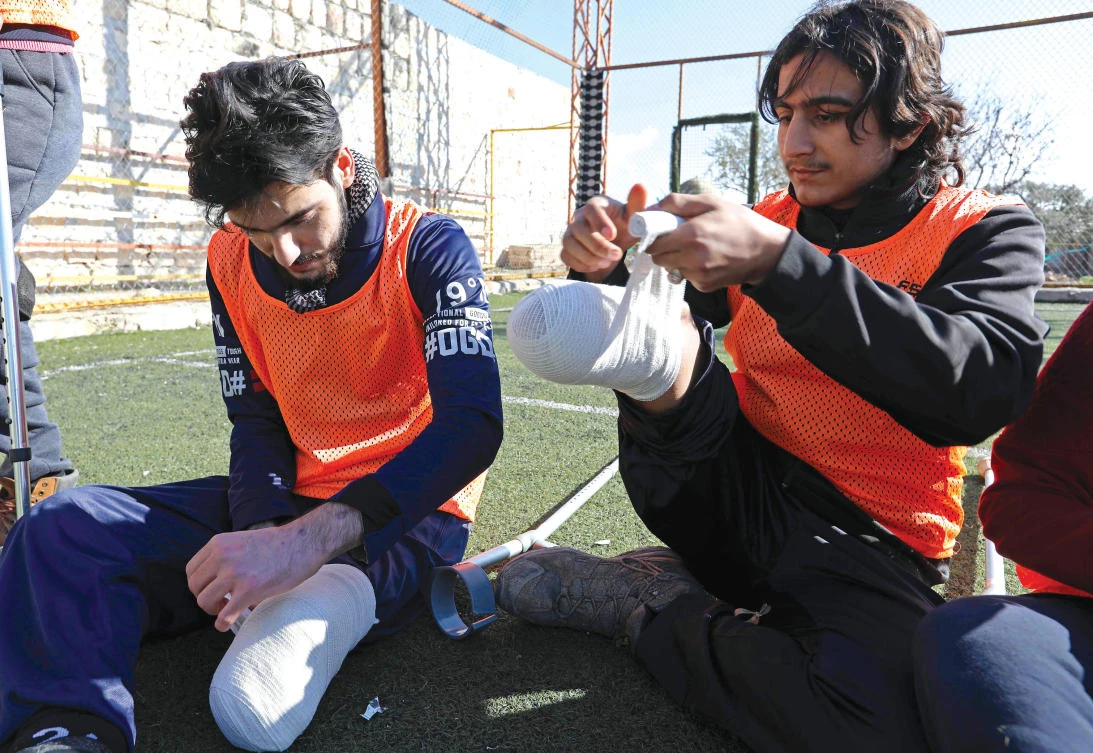 Syrian amputees who were handicapped in the war warm up prior to competing in a football match organized by a center for physical therapy in Idlib, the last province in the country outside the government's control. For the past month, a physiotherapy center in Syria's northwest province has been training 19 war-wounded men and boys to establish a football team. (AFP)