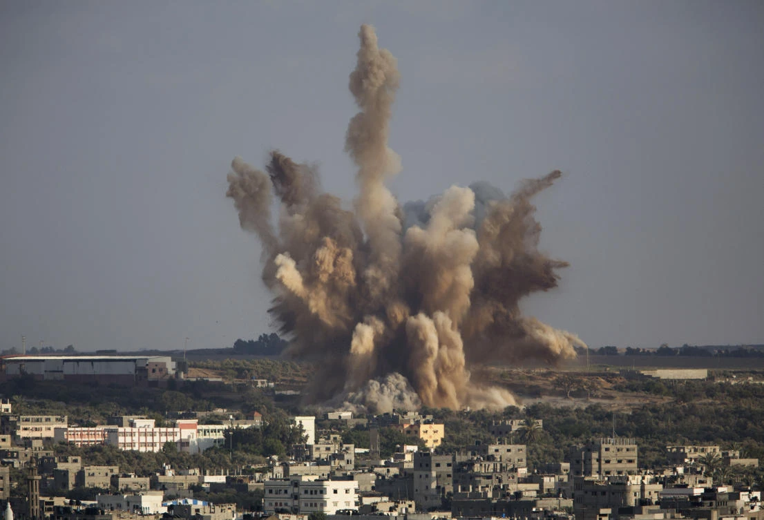 In this file photo smoke rises in Gaza City after an Israeli airstrike. Four years ago, Israel inflicted heavy damage on Gaza's infrastructure during a bruising 50-day war with Hamas militants. Now, fearing a humanitarian disaster on its doorstep, Israel is appealing to the world to fund a series of big-ticket development projects in the war-torn area. (AP/Dusan Vranic, File)