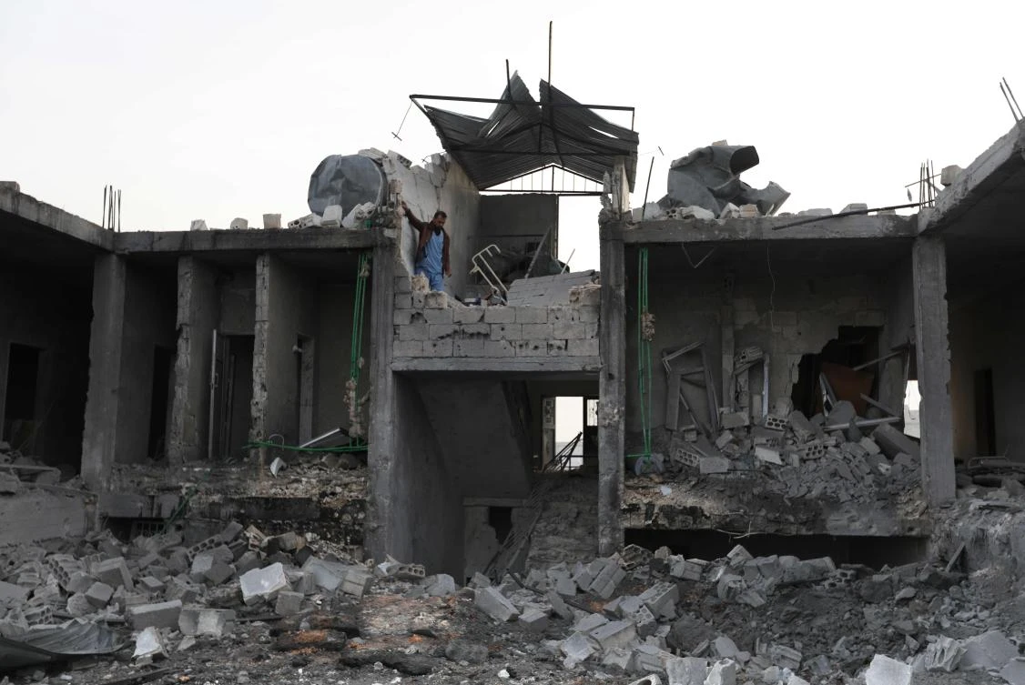 A Syrian medic checks the damage at the "Sham Surgical" hospital, one of several hospitals targeted by air strikes in Idlib province over the past few days, after it was hit in the night, in the town of Hass on Feb. 15, 2018. (AFP)