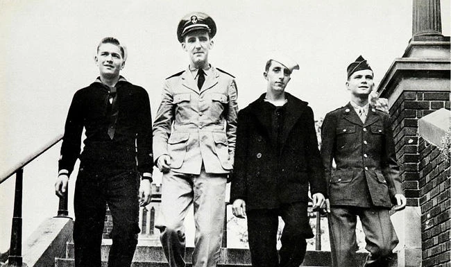 From left: Classmates John Marcil, John McGrath, Howard McAlonie and Alfred Mahoney in the military uniform walk down the stairs at Catholic Central High School in Troy, New York in this October 1943 photo. (Catholic Central High School via AP)
