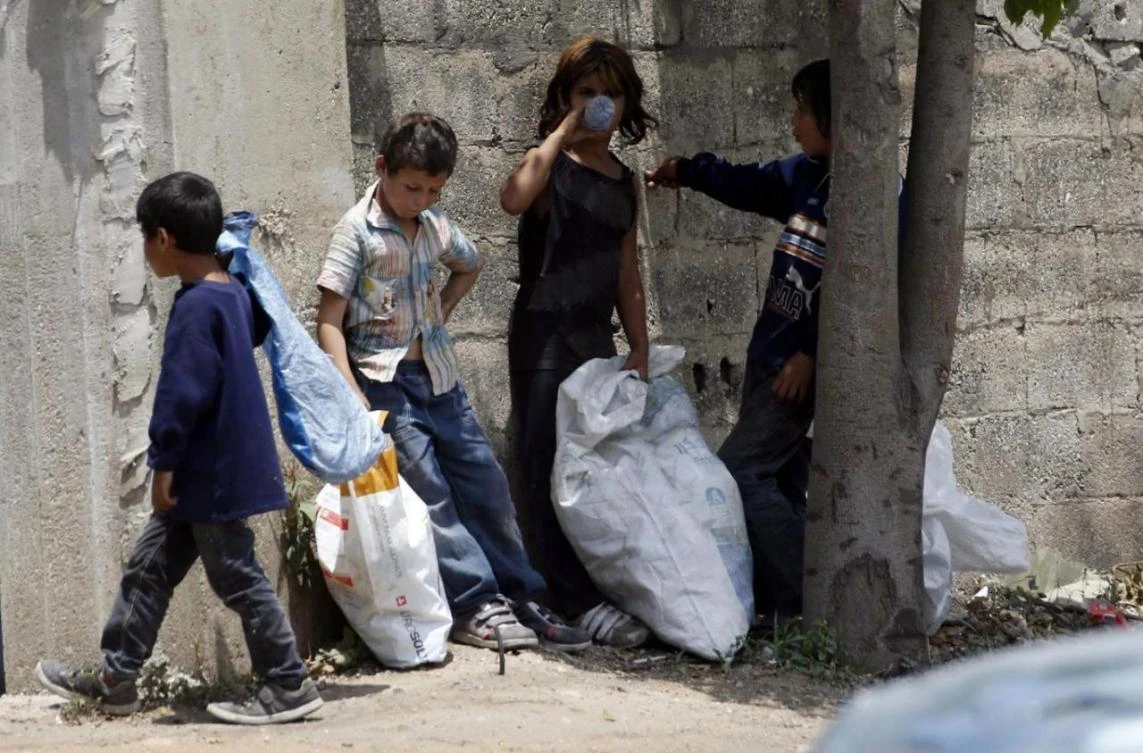 In this file photo, Syrian refugee children stand along a street in south of Sidon, southern Lebanon. (Reuters)