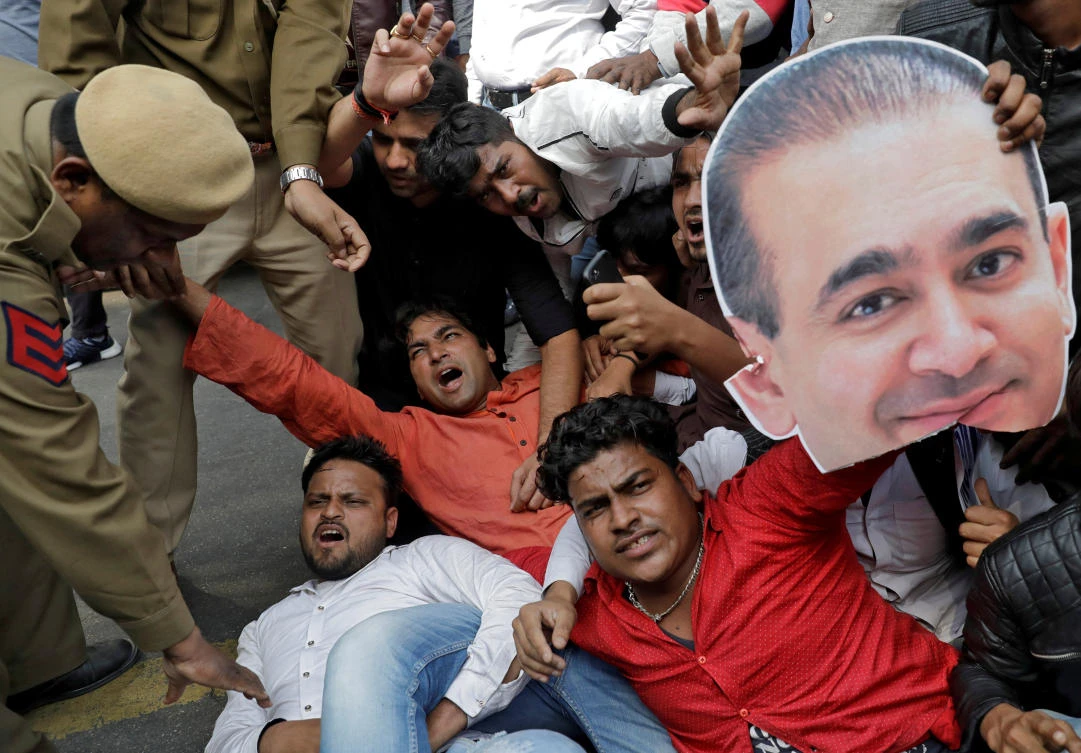 An activist of the youth wing of India’s main opposition Congress party holds a cut-out with an image of billionaire jeweller Nirav Modi during a protest against the ruling Bharatiya Janata Party (BJP) in New Delhi. Modi and another jeweler are under investigation for allegedly cheating Punjab National Bank of $43 million. (Reuters)