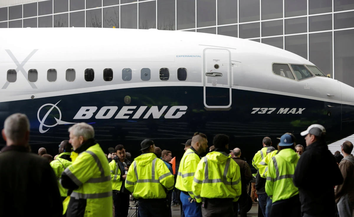 Employees are pictured as the first Boeing 737 MAX 7 is unveiled in Renton, Washington. (REUTERS)