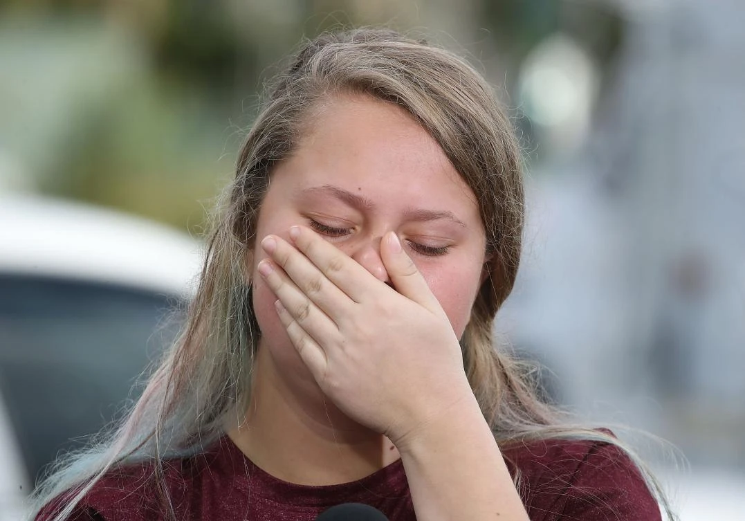 Student Kelsey Friend, becomes emotional while recounting her story about yesterday's mass shooting at the Marjory Stoneman Douglas High School where 17 people were killed, on February 15, 2018 in Parkland, Florida. (AFP)