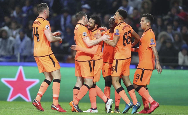 Liverpool's Mohamed Salah, 3rd left, celebrates after scoring his side's second goal during the Champions League round of sixteen first leg soccer match between FC Porto and Liverpool FC at the Dragao stadium in Porto, Portugal, on Feb. 14, 2018. (AP Photo/Luis Vieira)