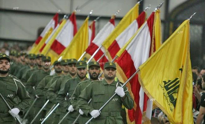 Hezbollah fighters march holding flags in this file photo. (AFP)