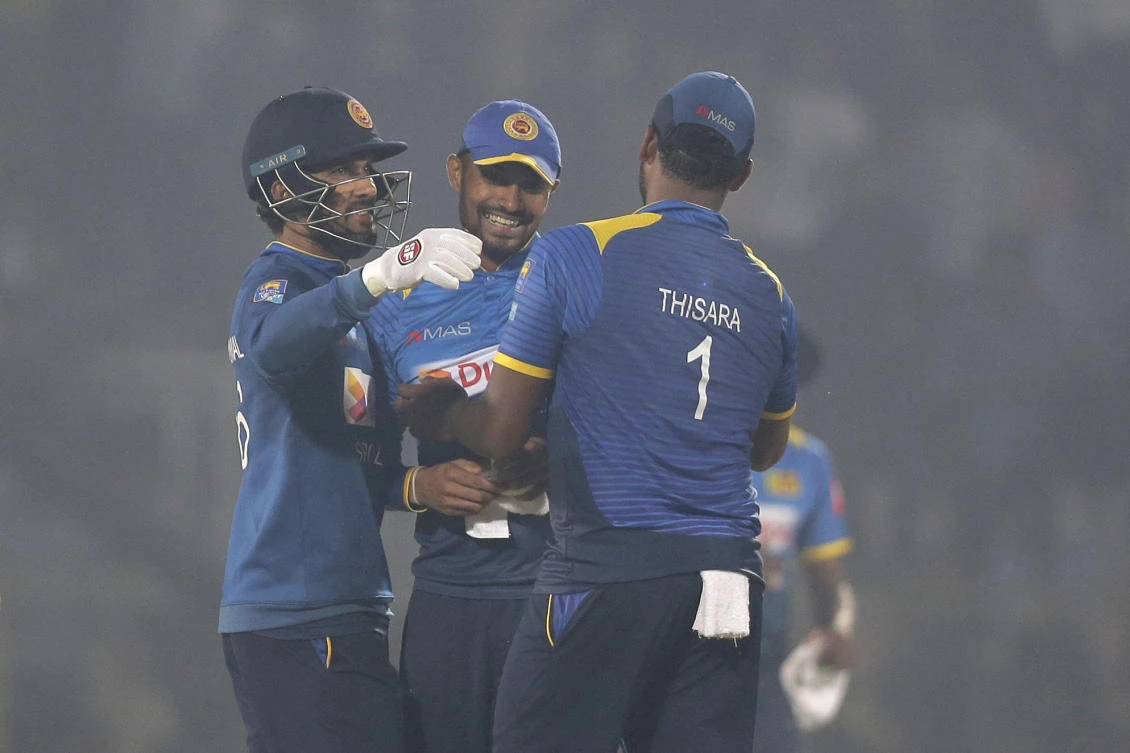 Sri Lanka's captain Dinesh Chandimal, left, and his teammates congratulate each other after win the second and final Twenty20 international cricket match against Bangladesh in Sylhet (AP Photo)