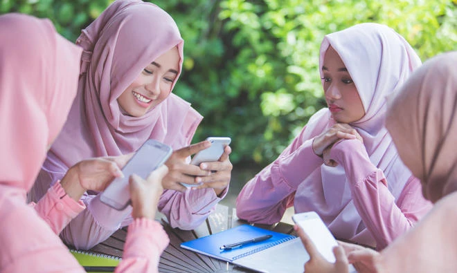 British police investigate abuse of head teacher at school that banned hijab