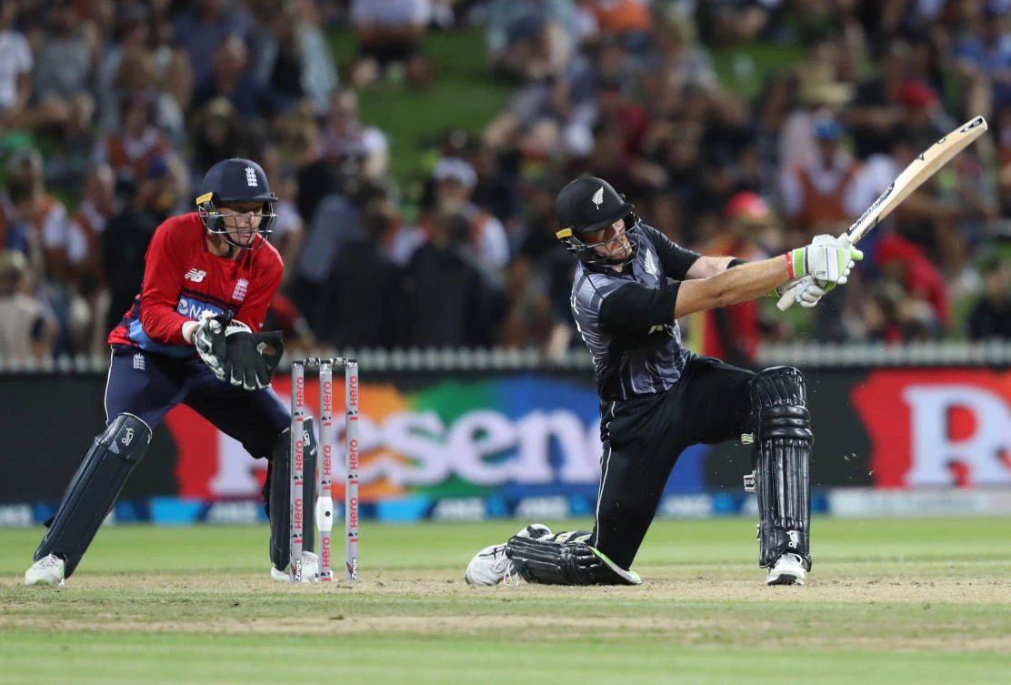 New Zealand’s Martin Guptill (R) bats watched by England’s wicketkeeper Jos Buttler (L) during the Twenty20 Tri Series international cricket match between New Zealand and England at Seddon Park in Hamilton on February 18, 2018. (AFP)