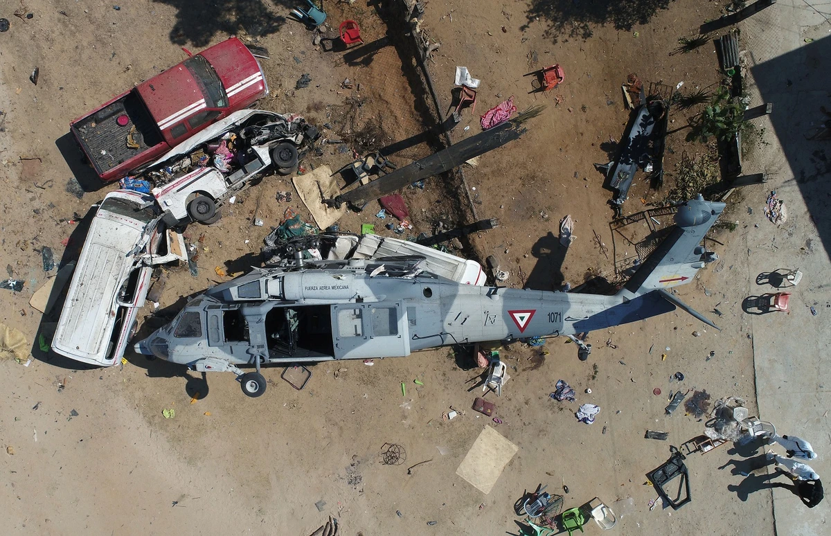 Aerial view of the military helicopter that fell on a van in Santiago Jamiltepec, Oaxaca state, Mexico, on Feb. 17, 2018. A 7.2-magnitude earthquake rattled Mexico on Friday, causing little damage but triggering a tragedy when a minister's helicopter crash-landed on the way to the epicenter, Oaxaca, killing thirteen people, including three children, on the ground. (Mario Vazquez/AFP)