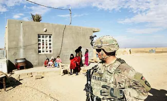 In this Jan. 27, 2018, photo, U.S. Army soldiers speak to families in rural Anbar on a reconnaissance patrol near a coalition outpost in western Iraq. (AP)