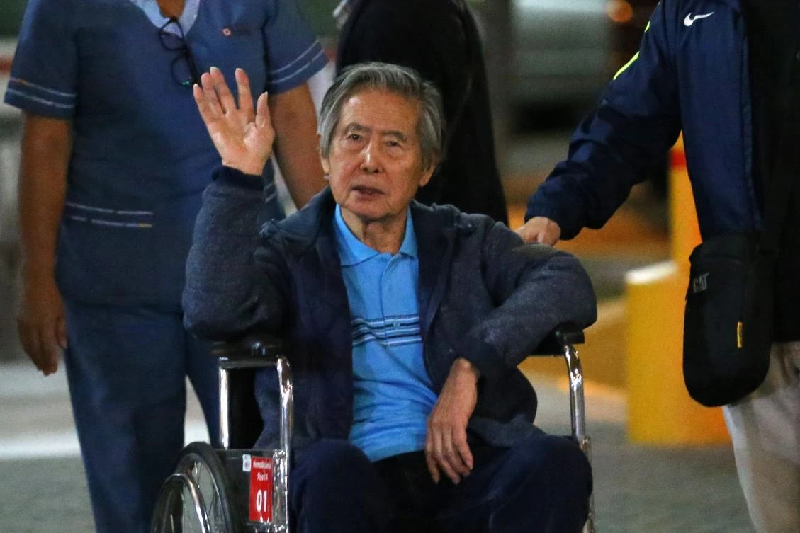 President Peruvian Alberto Fujimori waves to supporters as he is wheeled out of the Centenario Clinic in Lima, where he was hospitalized for the last twelve days, on January 4. Prosecutors are seeking 25 years in prison for the former leader in the latest case lodged against him. (AFP)