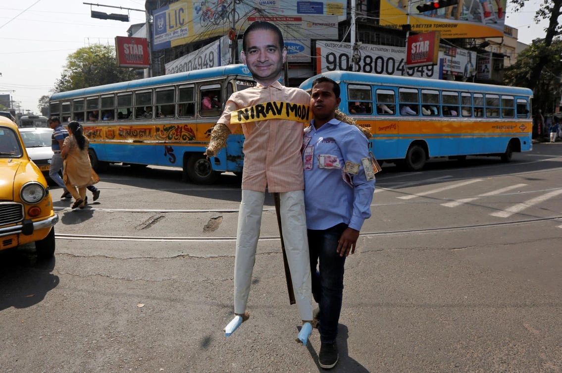 A demonstrator holds an effigy depicting billionaire jeweler Nirav Modi during a protest in Kolkata. Indian officials are on the lookout for Modi and his family, who police say left India in January prior to the case being filed. (Reuters)