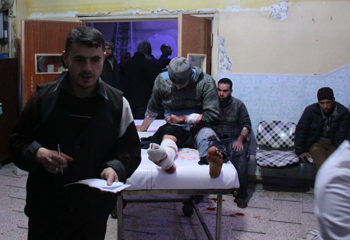 A wounded Syrian sits on a gurney as victims pour into a makeshift hospital in the rebel-held town of Douma, following air strikes by regime forces on the besieged Eastern Ghouta region on the outskirts of the capital Damascus. (AFP)