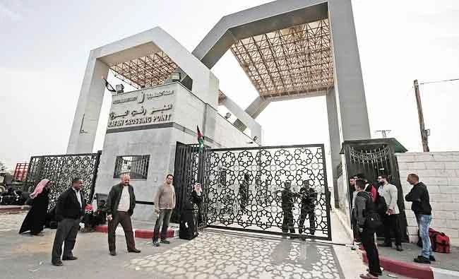 Palestinians wait for permission to cross into Egypt through the Rafah border crossing in the southern Gaza Strip after it was opened by Egyptian authorities for humanitarian cases, in this February 7, 2018 photo. (AFP)
