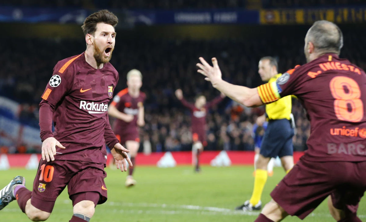 Barcelona's Lionel Messi celebrates with Andres Iniesta scoring his side's first goal during a Champions League round of sixteen first leg. (AP)