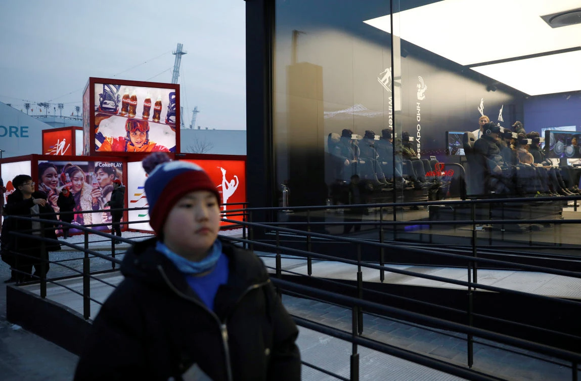 Visitors try out Samsung Electronics’ VR at its booth near the Medal Plaza in Pyeongchang. (Reuters)