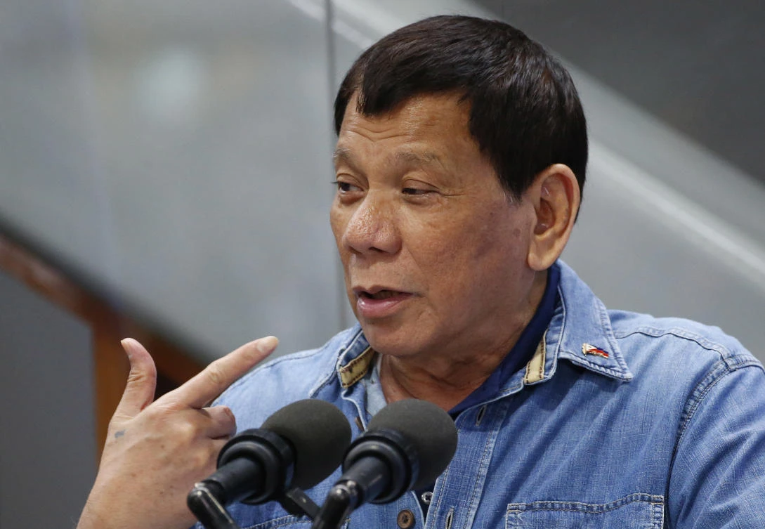 Philippine President Rodrigo Duterte gestures while addressing Filipino Overseas Workers who were repatriated from Kuwait, Tuesday, Feb. 13, 2018. (AP)