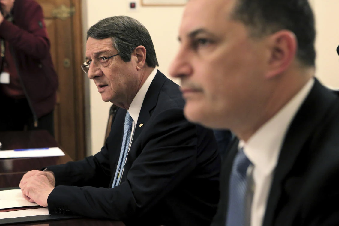 Cyprus' energy minister Yiorgos Lakkotrypis, right, and Cyprus' President Nicos Anastasiades attend a meeting with the leadership council of the island, at the Presidential palace in divided capital Nicosia, Cyprus, on Wednesday, Feb. 21, 2018. Cyprus' president Anastasiades says an offshore hydrocarbons search will carry on as planned despite strong opposition by Turkey and the ethnically split island nation's breakaway Turkish Cypriots. (AP Photo/Petros Karadjias)