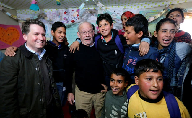 UNICEF Executive Director Anthony Lake (3rd L) stands with Justin Forsyth (L), chief executive of Save the Children, as they visit a school inside a refugee camp in Zahle, in the Bekaa Valley March 14, 2014. (REUTERS/Mohamed Azakir/File Photo)
