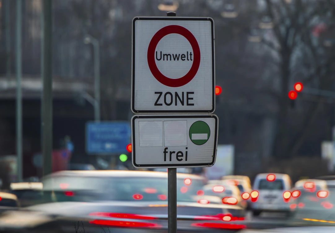 Cars pass by a sign reading ‘environment zone’ and allowing entrance just for cars with low emissions recognizable on a green sticker in Frankfurt, Germany. (dpa via AP)