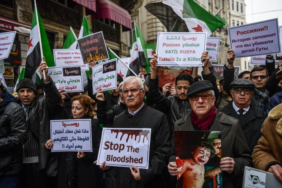 Syrian opposition politician George Sabra (C) takes part in a protest in front of Russian Consulate in Istanbul on Feb. 22, 2018 during a protest against the airstrikes and shelling by the Syrian government forces in Ghouta. (AFP)