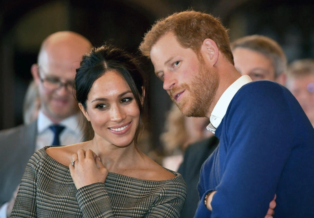 In this file photo, Britain’s Prince Harry talks to Meghan Markle as they watch a dance performance by Jukebox Collective in the banqueting hall during a visit to Cardiff Castle, Wales. (AP)