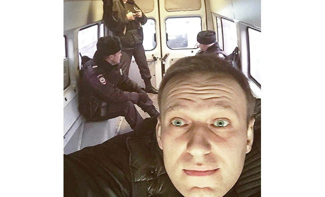 Russian opposition leader Alexei Navalny makes a selfie inside a police van after he was detained in Moscow Thursday. (AP)