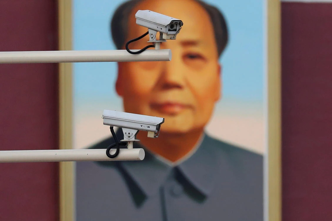Security cameras are seen in front of a portrait of late Chinese Chairman Mao in Beijing. Huawei is among the group’s seeking to establish market share as China becomes the world’s biggest 5G market. (Reuters)