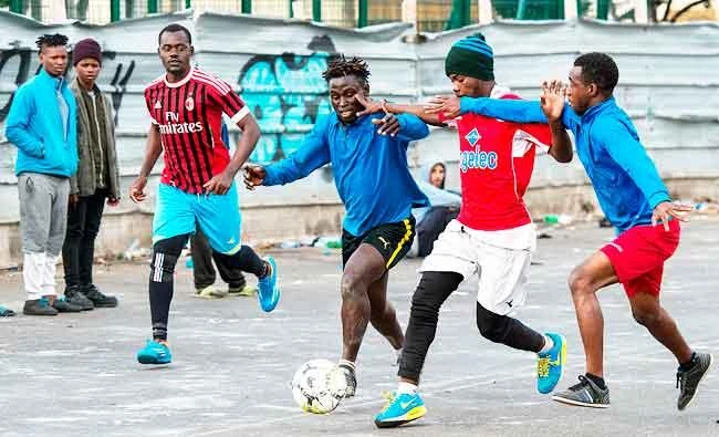 Sub-Saharan migrants play in a football match on a makeshift pitch in the middle of the Oulad Ziane migrant camp in Casablanca, in this February 19, 2018 photo. (AFP)