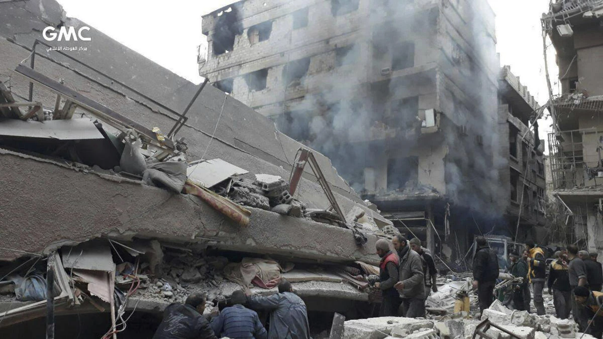 Syrians search for victims under the rubble of a destroyed building that attacked by Syrian government forces airstrikes, in Ghouta, a suburb of Damascus, Syria. (Ghouta Media Center via AP)