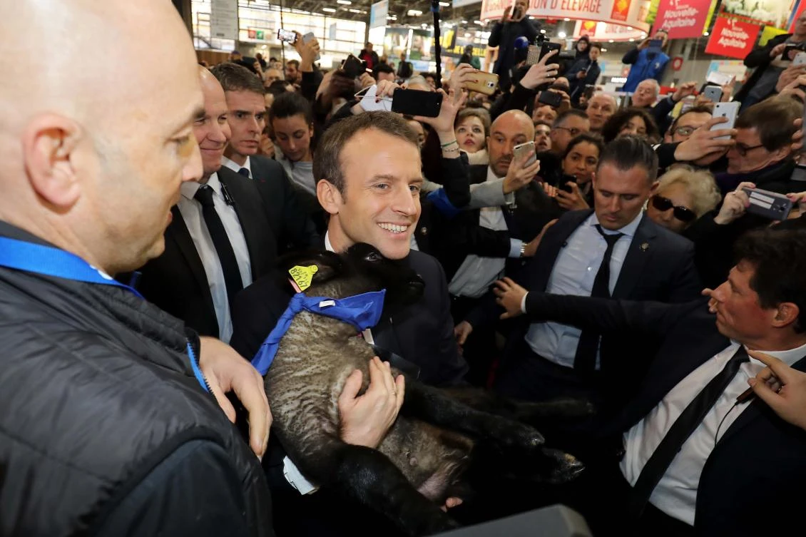 French President Emmanuel Macron holds a lamb as he visits the 55th International Agriculture Fair (Salon de l’Agriculture) in Paris, where disgruntled French farmers gave him a less than welcoming reception. (Reuters)