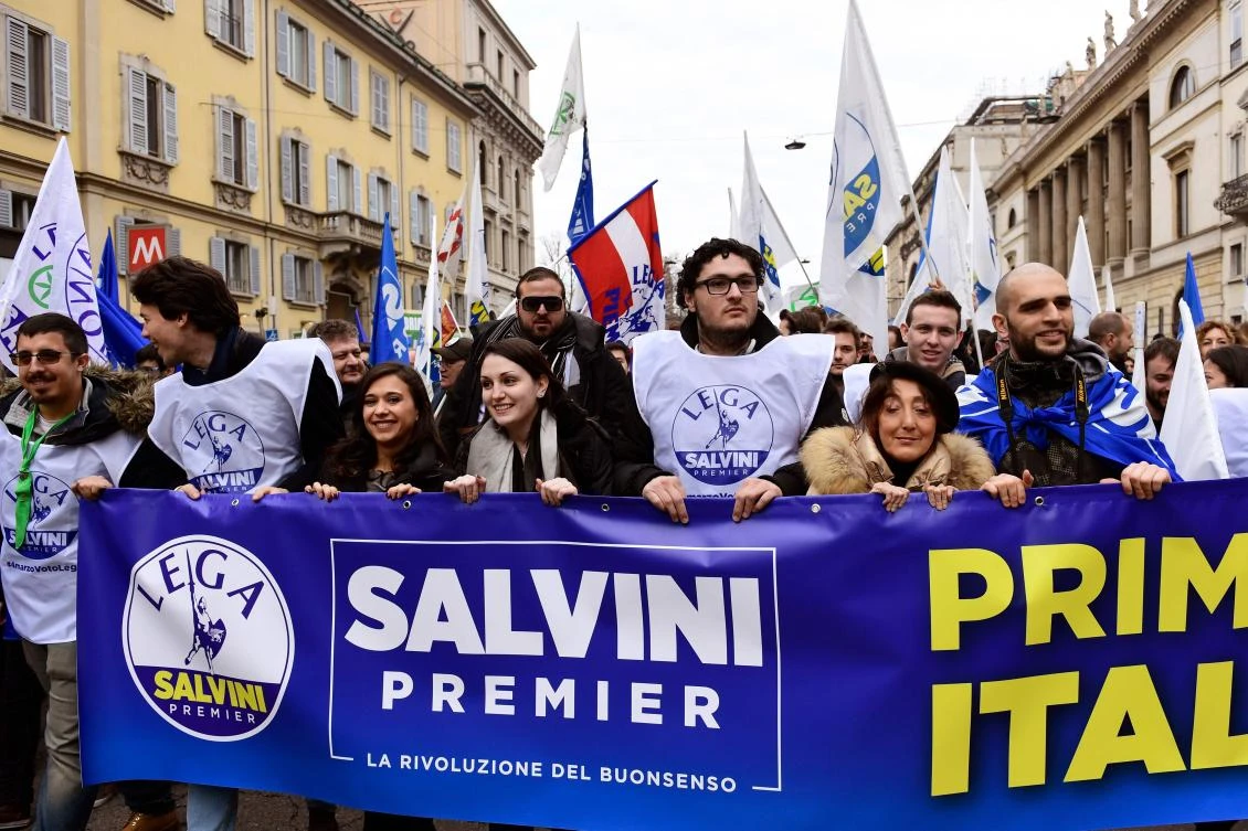 Italian far-right party Lega Nord’s (Northern League) supporters hold a banner reading “Salvini Prime Minister” as they take part in a campaign rally in Milan on Feb. 24, 2018 ahead of Italy’s general election. (AFP)