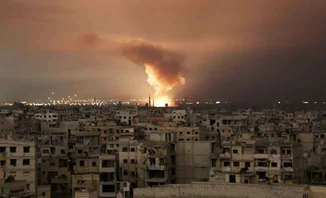 Smoke billows following a regime air strike on the besieged Eastern Ghouta region on the outskirts of the capital Damascus, late on February 23, 2018. (AFP)