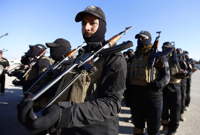 Iraqi policemen take part in a parade to mark the national police day on January 9, 2018 in the holy city of Najaf. (AFP)