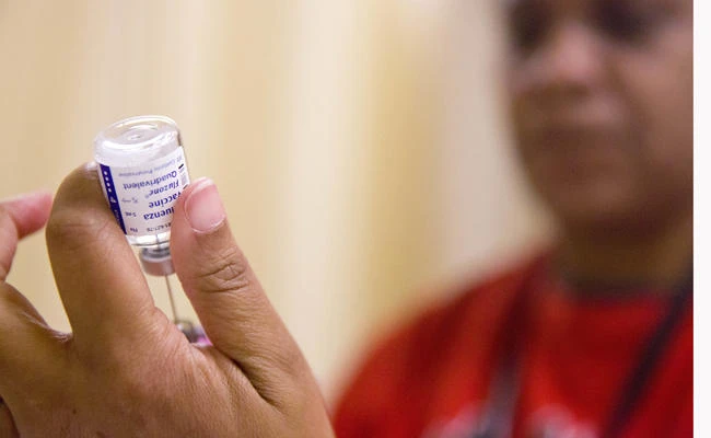 A nurse prepares a flu shot from a vaccine vial in this Feb. 7, 2018 file photo. Most doses of vaccine are made in a production process that involves growing viruses in chicken eggs. (AP Photo/David Goldman)