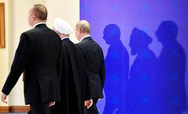 From L: Azerbaijan's President Ilham Aliyev, Iranian President Hassan Rouhani and Russian President Vladimir Putin leave after posing for photos ahead of their trilateral meeting in Tehran, in this November 1, 2017 file photo. (AFP)