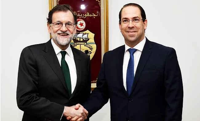 Tunisian Prime Minister Youssef Chahed (R) greets Spanish Prime Minister Mariano Rajoy on Monday in Tunis. (AFP)