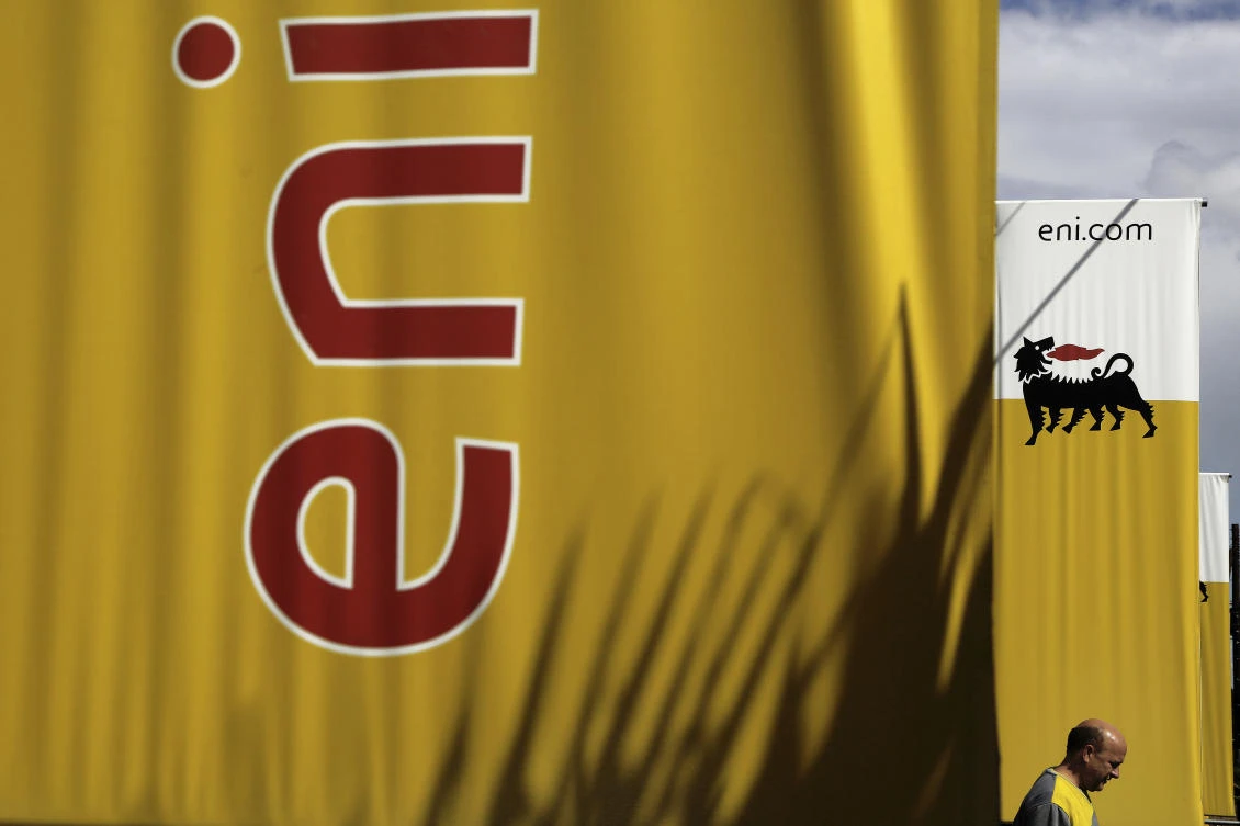 An employee walks by banners with name and sign of energy firm Eni at Strovolos area in capital Nicosia, Cyprus. (AP)