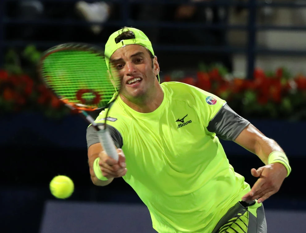 Tunisia's Malek Jaziri returns the ball to Grigor Dimitrov of Bulgaria during their Dubai Duty Free Tennis singles match on February 27, 2018. (AFP)
