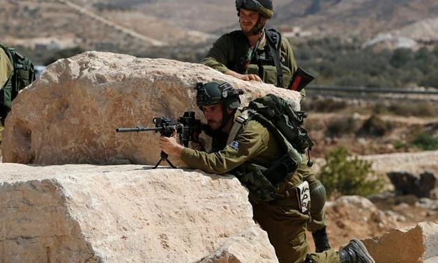 In this file photo, an Israeli army soldier aims his weapon during clashes following a protest by Palestinians against closure of a road south of Gaza. (REUTERS)